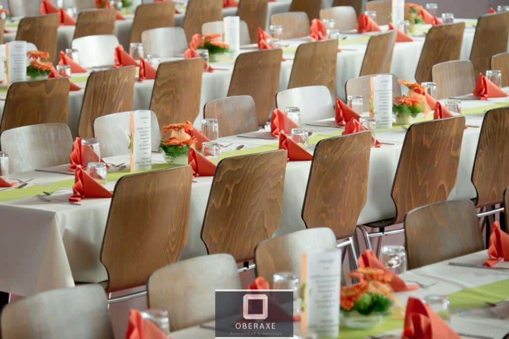 Long Tables With White Cloths and Brown Chairs Formal Setting