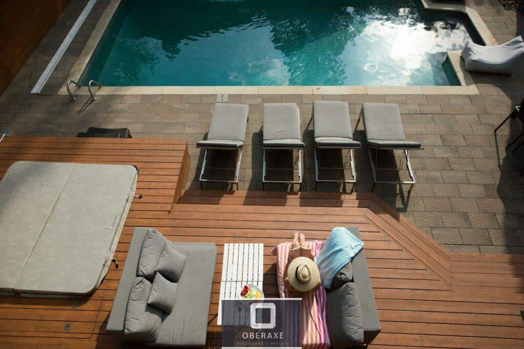 four gray loungers near pool